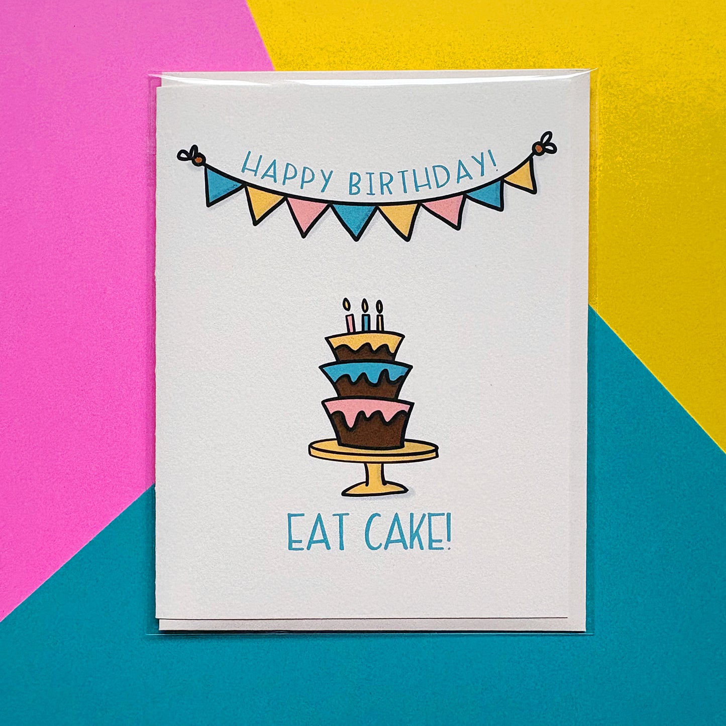 Birthday card with a cake illustration and 'Happy Birthday! Eat Cake!' text on a colorful background.
