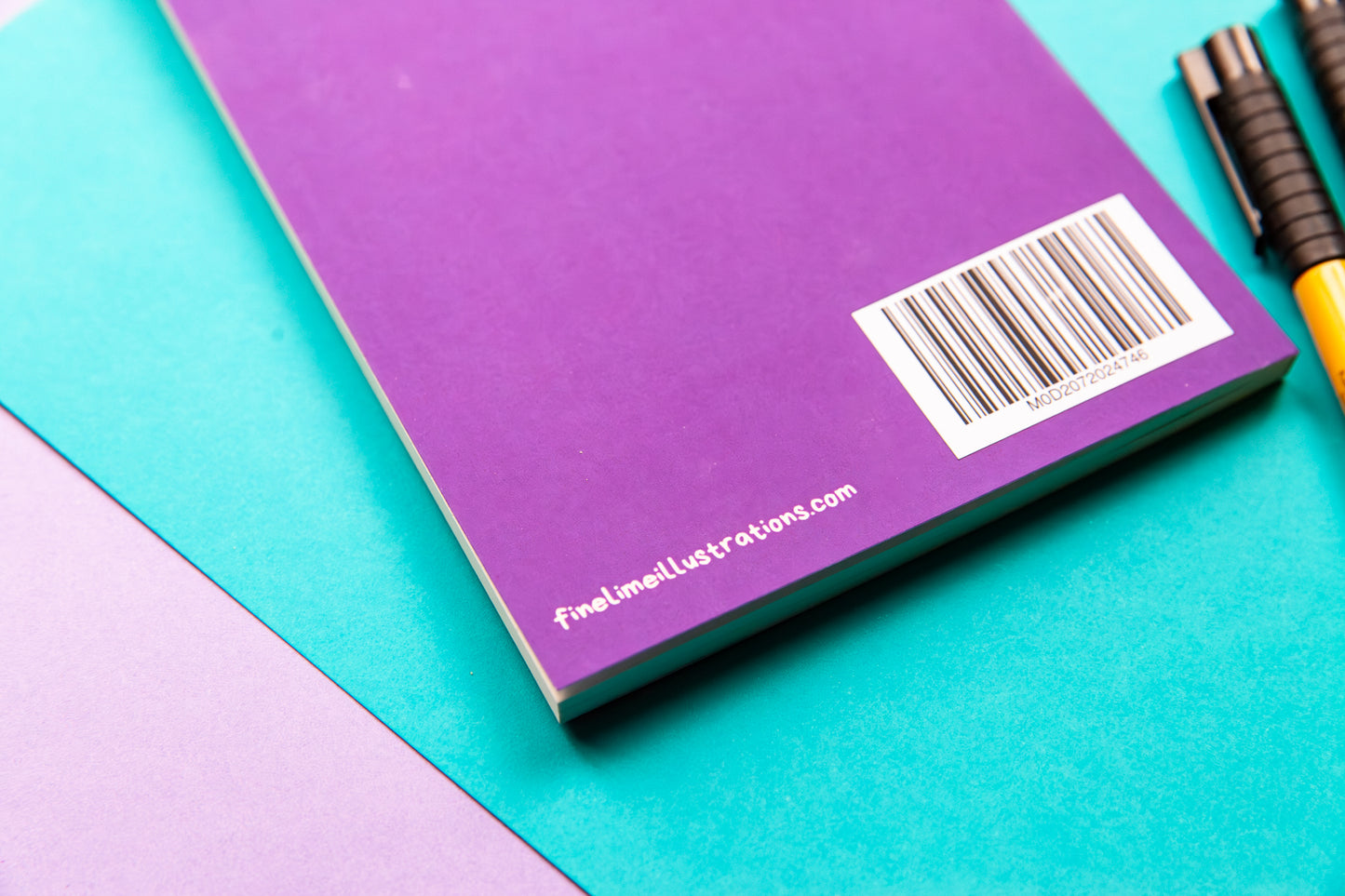 The back cover of a purple notebook showing the bar code and the company website information